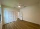 Bedroom featuring wood-look flooring, a modern ceiling fan and closet with bright white doors at 3616 Bellefonte Ave, North Port, FL 34286