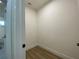A simple walk-in closet with clean, neutral walls and light wood-look flooring provides ample storage at 3616 Bellefonte Ave, North Port, FL 34286