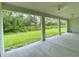 Open-air covered patio offers views of the home's lush green backyard at 3616 Bellefonte Ave, North Port, FL 34286
