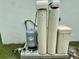 Well equipment and water filtration system in a tidy, landscaped home yard at 3616 Bellefonte Ave, North Port, FL 34286
