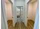 Hallway featuring wood-look flooring and doorways to other rooms including a bathroom at 3616 Bellefonte Ave, North Port, FL 34286