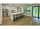 Open kitchen featuring an island with bar seating, white cabinetry, and stainless steel appliances at 3616 Bellefonte Ave, North Port, FL 34286