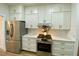 Well-equipped kitchen with white cabinets, stainless steel appliances, and a stylish backsplash at 3616 Bellefonte Ave, North Port, FL 34286