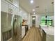 Modern kitchen featuring white cabinets, stainless steel appliances, and an island with a farmhouse sink at 3616 Bellefonte Ave, North Port, FL 34286