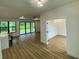 Open-concept space featuring wood floors, recessed lighting, and large sliding glass doors to backyard at 3616 Bellefonte Ave, North Port, FL 34286