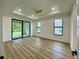 Main bedroom featuring wood-look flooring, recessed lighting, ceiling fan and sliding glass doors at 3616 Bellefonte Ave, North Port, FL 34286