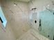 Modern, tiled walk-in shower with a glass enclosure and black fixtures to create a luxurious, contemporary bathroom at 3616 Bellefonte Ave, North Port, FL 34286