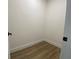 Walk-in closet featuring wood-look flooring at 3616 Bellefonte Ave, North Port, FL 34286