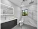Modern bathroom with walk-in shower, floating vanity, stylish tile, and natural light at 3636 Mineola, Sarasota, FL 34239