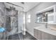 Modern bathroom featuring walk-in shower with elegant marble tile, floating vanity, and stylish fixtures at 3636 Mineola, Sarasota, FL 34239