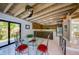 Lovely dining area with wooden ceiling beams and an adjacent open kitchen at 3636 Mineola, Sarasota, FL 34239