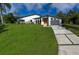 Beautiful modern home with lush green lawn and stylish contemporary design, perfect curb appeal at 3636 Mineola, Sarasota, FL 34239