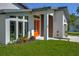 Stylish front entry showcasing a vibrant orange door with a contemporary design at 3636 Mineola, Sarasota, FL 34239