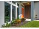 Eye-catching front entrance with a vibrant orange door and modern architectural details at 3636 Mineola, Sarasota, FL 34239