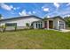 A modern home featuring a well-manicured lawn, contemporary architectural design, and a striking red door at 3636 Mineola, Sarasota, FL 34239