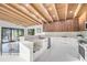 Modern kitchen with a breakfast bar, white marble countertops, and stainless steel appliances at 3636 Mineola, Sarasota, FL 34239