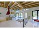 Bright living area with exposed wood beams, fireplace, and sliding glass doors to the pool at 3636 Mineola, Sarasota, FL 34239