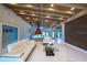 Spacious living room with high ceilings, wooden beams, white sofas, and modern decor at 3636 Mineola, Sarasota, FL 34239