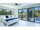 Bright main bedroom with a queen bed and sliding glass doors to the outside at 3636 Mineola, Sarasota, FL 34239