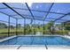 Gorgeous screened pool overlooking lush greenery and waterfront view, ideal for serene relaxation at 3636 Mineola, Sarasota, FL 34239