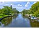 Scenic canal view with lush greenery, boat docks, and serene waterfront atmosphere at 3636 Mineola, Sarasota, FL 34239