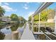 Waterfront property featuring a private dock, boat lift, and canal views at 3636 Mineola, Sarasota, FL 34239