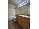 Clean bathroom featuring a tile floor, single sink vanity, and a shower/tub combo at 4002 Crockers Lake Blvd # 11, Sarasota, FL 34238