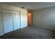 Bedroom featuring double door closet and light-colored carpet, offering ample space for storage at 4002 Crockers Lake Blvd # 11, Sarasota, FL 34238