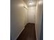 Inviting hallway featuring wood-style flooring and a closet for extra storage and convenience at 4002 Crockers Lake Blvd # 11, Sarasota, FL 34238
