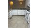 Galley kitchen with white cabinets, neutral countertop and standard appliances at 4002 Crockers Lake Blvd # 11, Sarasota, FL 34238