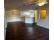 Spacious living room featuring hardwood floors open to a kitchen and dining area at 4002 Crockers Lake Blvd # 11, Sarasota, FL 34238