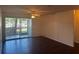 Bright and airy living room with hardwood floors and sliding glass doors to screened porch at 4002 Crockers Lake Blvd # 11, Sarasota, FL 34238