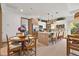 Well-lit modern kitchen with a dining table, pendant lighting, stainless steel appliances, and an island at 405 Sunset N Rd, Rotonda West, FL 33947