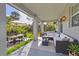 Spacious outdoor patio with ample seating, dining area and beautiful backyard at 405 Sunset N Rd, Rotonda West, FL 33947