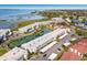 Aerial view of waterfront condos with well-maintained landscaping, parking, and a scenic waterway at 4414 Mount Vernon Dr # 1, Bradenton, FL 34210