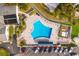 Aerial view of a large community pool, surrounded by lounge chairs, well-manicured landscaping, and ample parking at 4414 Mount Vernon Dr # 1, Bradenton, FL 34210