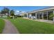 Spacious backyard with lush green lawn, walkway, patio seating, and pond at 4414 Mount Vernon Dr # 1, Bradenton, FL 34210