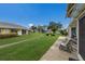Lush green backyard with walkway, patio seating, and water views at 4414 Mount Vernon Dr # 1, Bradenton, FL 34210