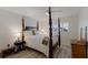 Traditional bedroom boasts a four-poster bed with white bedding and shutters on the window at 4414 Mount Vernon Dr # 1, Bradenton, FL 34210