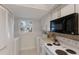 Bright kitchen with white cabinets, modern appliances, and practical laundry setup at 4414 Mount Vernon Dr # 1, Bradenton, FL 34210