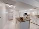 Bright kitchen featuring an island with breakfast bar and views of the entryway at 4414 Mount Vernon Dr # 1, Bradenton, FL 34210