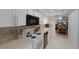 Well-equipped kitchen featuring white cabinetry, modern appliances, and an open design at 4414 Mount Vernon Dr # 1, Bradenton, FL 34210