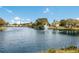 Beautiful lake view featuring a fountain, lush greenery, and clear skies, creating a peaceful ambiance at 4414 Mount Vernon Dr # 1, Bradenton, FL 34210