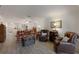 Open living room with cozy seating, wood floors, and access to a dining area and other spaces at 4414 Mount Vernon Dr # 1, Bradenton, FL 34210