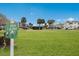 Manicured Pitch & Putt golf area on community grounds with tropical palms against a blue sky at 4414 Mount Vernon Dr # 1, Bradenton, FL 34210