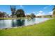 Scenic view of a pond with lush green grass surrounding the water's edge on a sunny day at 4414 Mount Vernon Dr # 1, Bradenton, FL 34210