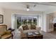 Bright sunroom with comfortable seating and a large window offering picturesque views of the surrounding landscape at 4414 Mount Vernon Dr # 1, Bradenton, FL 34210