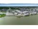 High-angle shot of the community situated on a lake, featuring walking paths, lush landscapes, and modern buildings at 4728 Old Blush St, Bradenton, FL 34211