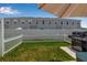 Well-maintained backyard with lush green grass, a white picket fence, and an outdoor grill for barbecues at 4728 Old Blush St, Bradenton, FL 34211