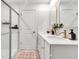 Bright bathroom featuring double sinks, gold hardware, a glass enclosed shower, and modern mirrors at 4728 Old Blush St, Bradenton, FL 34211